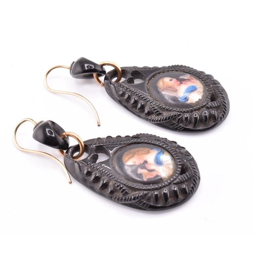 38A - A pair of Victorian carved jet portrait pendant earrings. The Victorian jet earrings having an oval ... 