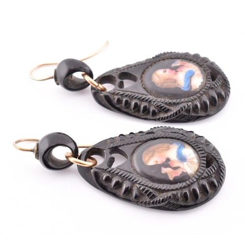 38A - A pair of Victorian carved jet portrait pendant earrings. The Victorian jet earrings having an oval ... 