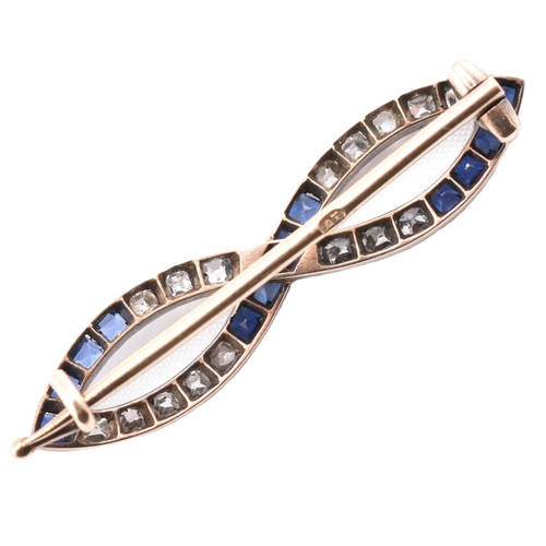 40 - A early 20th century sapphire and diamond brooch pin. The pin set with square cut diamonds and sapph... 