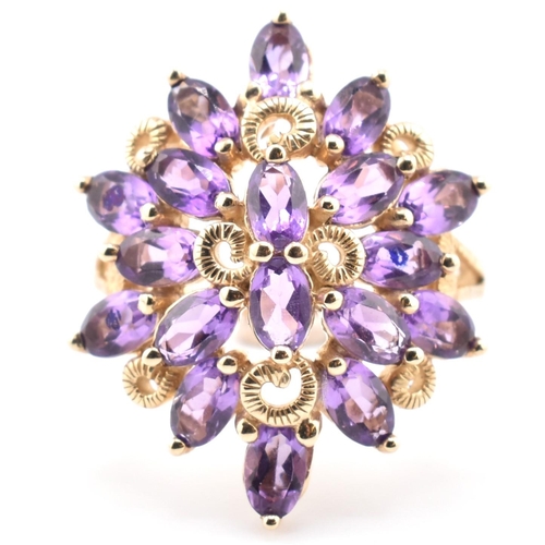 43 - A hallmarked 9ct gold and amethyst cluster ring. The 9ct yellow gold ring having a cluster of 18 ova... 