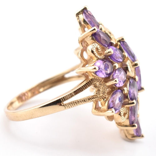 43 - A hallmarked 9ct gold and amethyst cluster ring. The 9ct yellow gold ring having a cluster of 18 ova... 