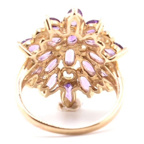 43 - A hallmarked 9ct gold and amethyst cluster ring. The 9ct yellow gold ring having a cluster of 18 ova... 