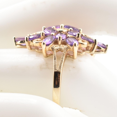 43 - A hallmarked 9ct gold and amethyst cluster ring. The 9ct yellow gold ring having a cluster of 18 ova... 