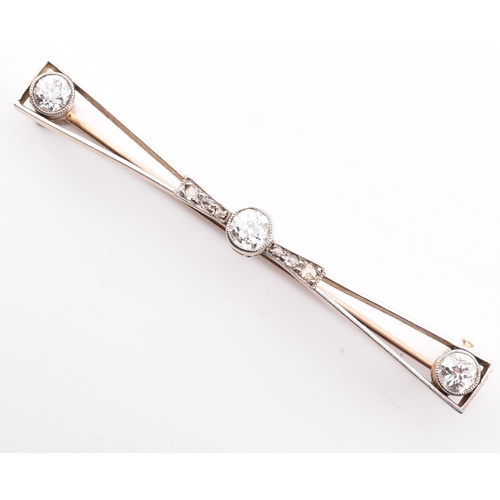 44a - A 1920s gold, platinum and diamond brooch pin. The brooch pin having a central millegrain set old cu... 