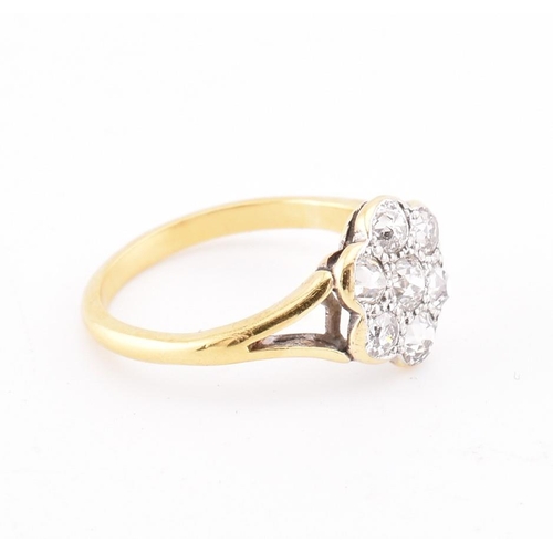 45 - An early 20th-century 18ct gold and diamond cluster ring. The ring set with seven old cut diamonds t... 