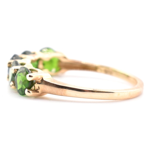 48 - A hallmarked 9ct gold and chrome diopside five stone ring. The ring having a single row of five shar... 