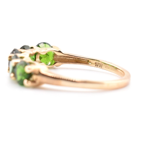 48 - A hallmarked 9ct gold and chrome diopside five stone ring. The ring having a single row of five shar... 