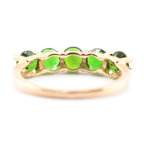 48 - A hallmarked 9ct gold and chrome diopside five stone ring. The ring having a single row of five shar... 