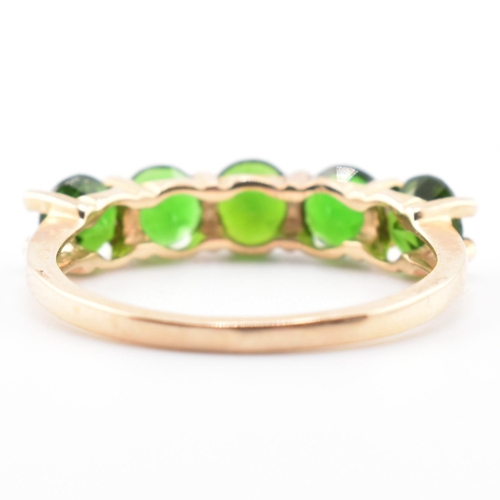 48 - A hallmarked 9ct gold and chrome diopside five stone ring. The ring having a single row of five shar... 