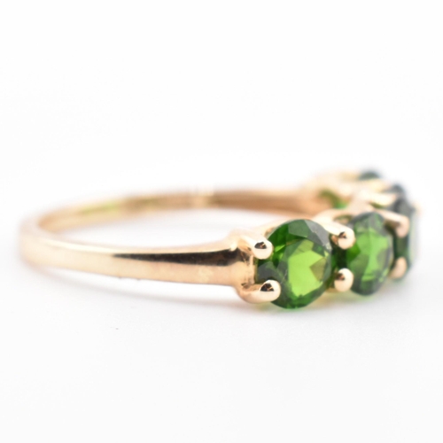 48 - A hallmarked 9ct gold and chrome diopside five stone ring. The ring having a single row of five shar... 