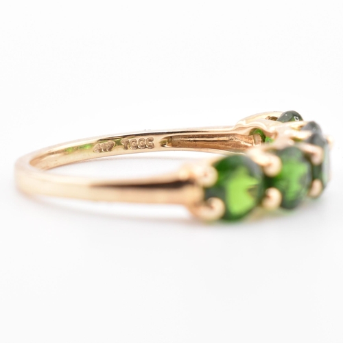 48 - A hallmarked 9ct gold and chrome diopside five stone ring. The ring having a single row of five shar... 