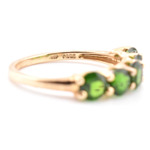 48 - A hallmarked 9ct gold and chrome diopside five stone ring. The ring having a single row of five shar... 