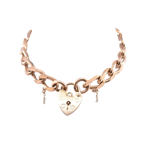 49 - A hallmarked 9ct gold curb link chain bracelet with a heart padlock clasp. The hallmarked 9ct gold c... 