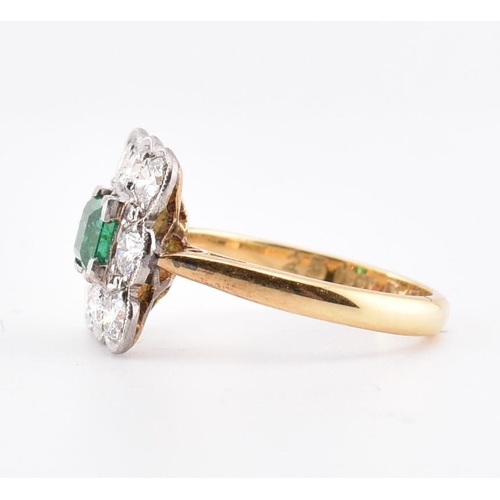 5 - An 18ct gold and platinum, emerald and diamond cluster ring. The 18ct yellow gold ring having a cent... 