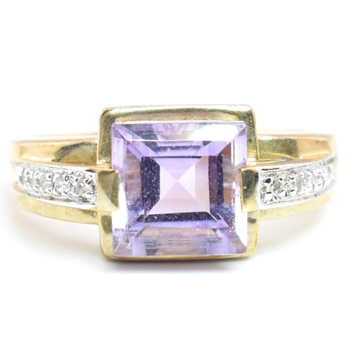 513 - A hallmarked 9ct gold amethyst and diamond ring. The ring set with a central step-cut amethyst to di... 