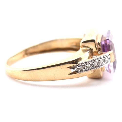 513 - A hallmarked 9ct gold amethyst and diamond ring. The ring set with a central step-cut amethyst to di... 