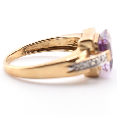 513 - A hallmarked 9ct gold amethyst and diamond ring. The ring set with a central step-cut amethyst to di... 