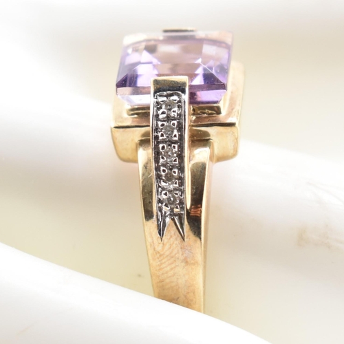 513 - A hallmarked 9ct gold amethyst and diamond ring. The ring set with a central step-cut amethyst to di... 