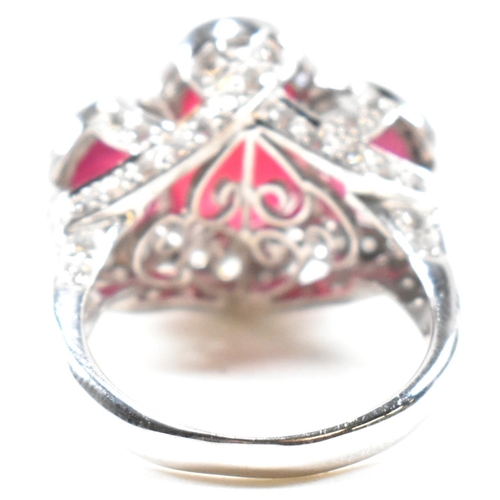 51a - An impressive 18ct white gold three stone ruby and diamond ring. The ring set with three graduating ... 