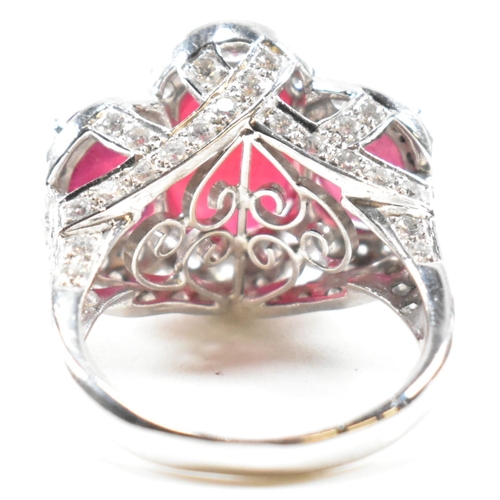 51a - An impressive 18ct white gold three stone ruby and diamond ring. The ring set with three graduating ... 