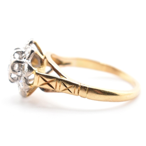 53a - A hallmarked 18 ct gold and diamond flower cluster ring. The ring set with a central round brilliant... 