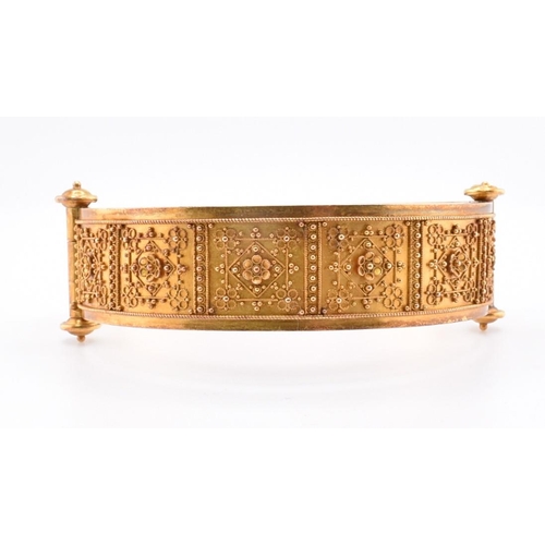 55 - A Victorian gold Roma Etruscan style bangle cased. The Victorian gold Archaeological Revival hinged ... 