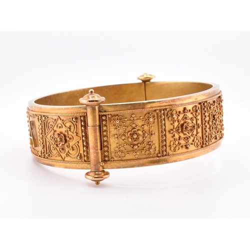 55 - A Victorian gold Roma Etruscan style bangle cased. The Victorian gold Archaeological Revival hinged ... 