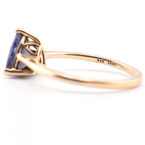 58 - A hallmarked 14 ct gold and Tanzanite Tomas Rae ring. The 14ct yellow gold ring set with a single tr... 