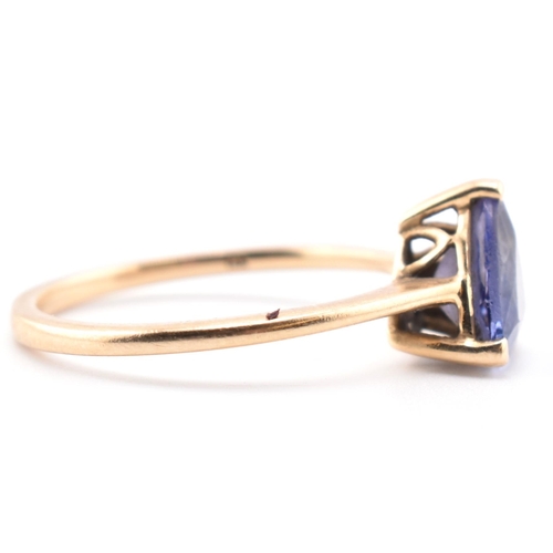 58 - A hallmarked 14 ct gold and Tanzanite Tomas Rae ring. The 14ct yellow gold ring set with a single tr... 