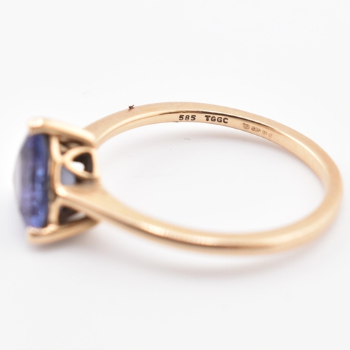 58 - A hallmarked 14 ct gold and Tanzanite Tomas Rae ring. The 14ct yellow gold ring set with a single tr... 