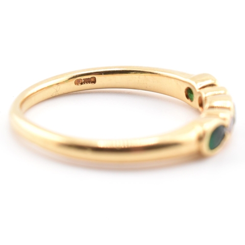 58a - A hallmarked 18ct gold emerald and diamond five-stone ring. The ring having three oval cut emeralds ... 