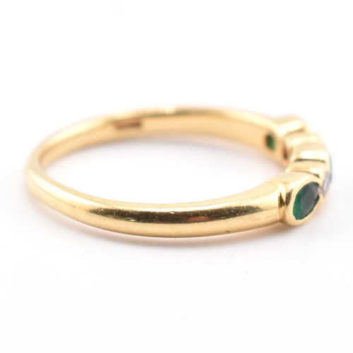 58a - A hallmarked 18ct gold emerald and diamond five-stone ring. The ring having three oval cut emeralds ... 