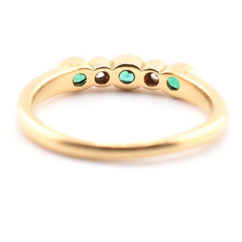 58a - A hallmarked 18ct gold emerald and diamond five-stone ring. The ring having three oval cut emeralds ... 