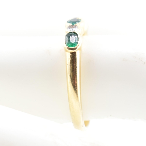 58a - A hallmarked 18ct gold emerald and diamond five-stone ring. The ring having three oval cut emeralds ... 