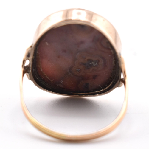 59a - A 19th century gold hard stone cameo ring. The ring set with an oval cameo of a maiden. The hardston... 