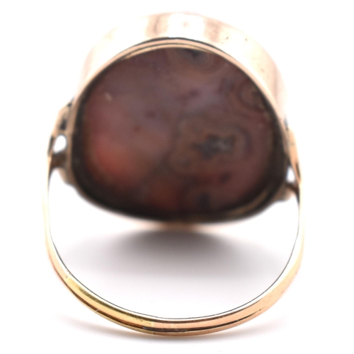 59a - A 19th century gold hard stone cameo ring. The ring set with an oval cameo of a maiden. The hardston... 