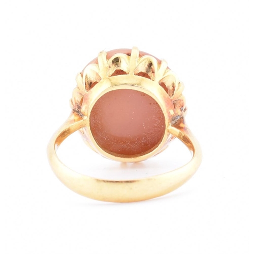 67 - A gold and agate ring. The ring having a claw set round agate cabochon to tapered shoulders and poli... 