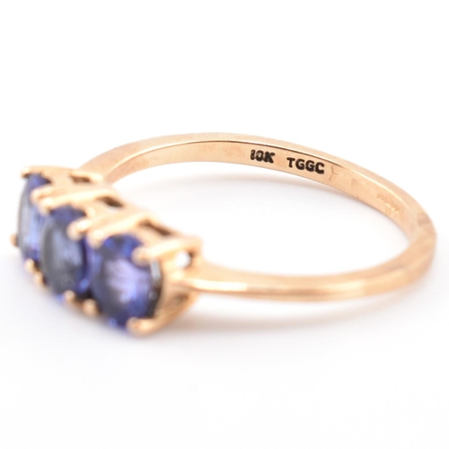 68 - A hallmarked 9ct gold and tanzanite three stone ring. The ring set with three four-prong set oval cu... 