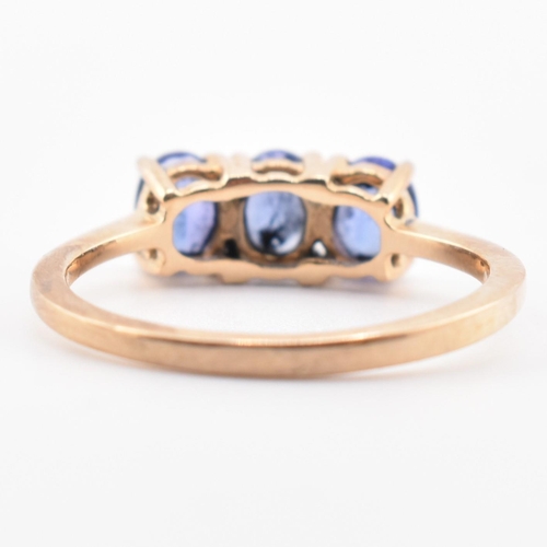 68 - A hallmarked 9ct gold and tanzanite three stone ring. The ring set with three four-prong set oval cu... 