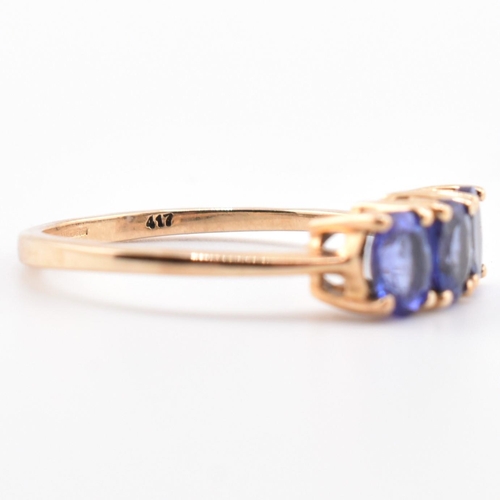 68 - A hallmarked 9ct gold and tanzanite three stone ring. The ring set with three four-prong set oval cu... 