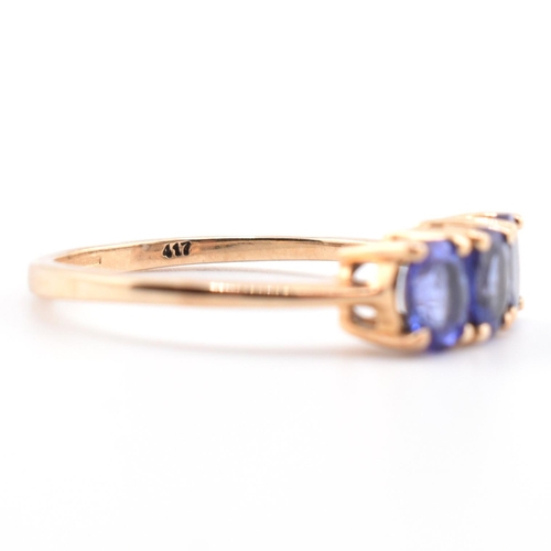 68 - A hallmarked 9ct gold and tanzanite three stone ring. The ring set with three four-prong set oval cu... 