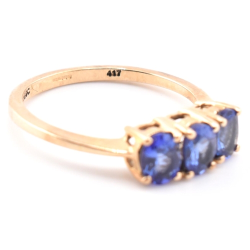 68 - A hallmarked 9ct gold and tanzanite three stone ring. The ring set with three four-prong set oval cu... 