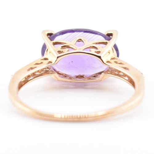 73 - A hallmarked 9ct Rio Grande amethyst and diamond ring. The ring having an east-west set oval cut Rio... 