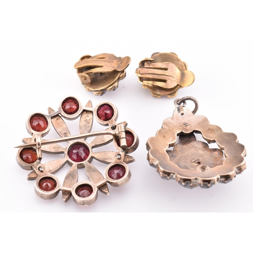 74 - A collection of Bohemian garnet jewellery. The lot to include a garnet set hinged bangle with concea... 