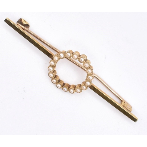 75 - A 15ct yellow gold pearl brooch with case. The 15ct yellow gold bar brooch having eighteen millegrai... 