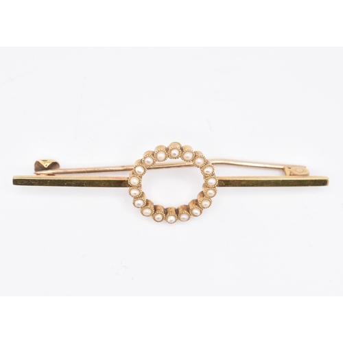 75 - A 15ct yellow gold pearl brooch with case. The 15ct yellow gold bar brooch having eighteen millegrai... 