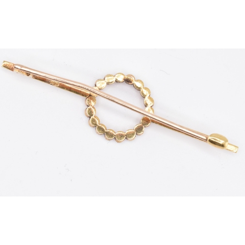 75 - A 15ct yellow gold pearl brooch with case. The 15ct yellow gold bar brooch having eighteen millegrai... 