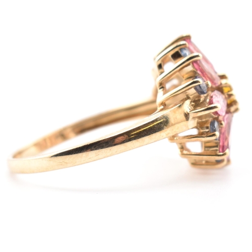 78 - A hallmarked 9ct gold, sapphire and tourmaline flower cluster ring. The 9ct yellow gold ring having ... 