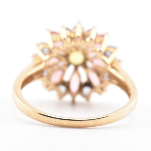 78 - A hallmarked 9ct gold, sapphire and tourmaline flower cluster ring. The 9ct yellow gold ring having ... 