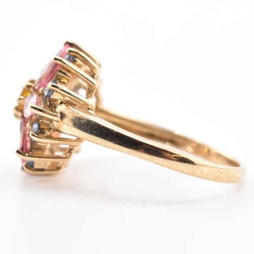 78 - A hallmarked 9ct gold, sapphire and tourmaline flower cluster ring. The 9ct yellow gold ring having ... 